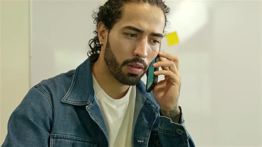 Person taking notes while working on a laptop - Free Stock Video