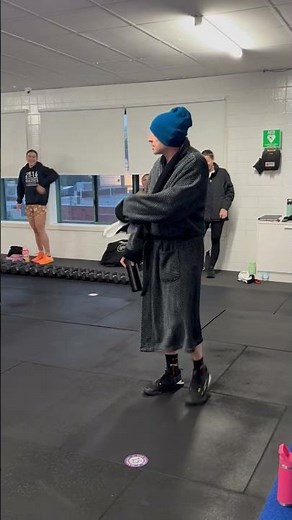 Man walks into the gym wearing a beanie and his robe!