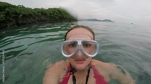woman snorkel beach mask wearing having fun in the ocean water, summer underwater sports