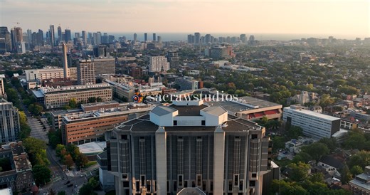 Aerial View of University Campus with Downtown Skyline at Golden Hour