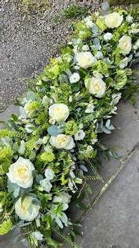 Creating posy arrangements to dress a coffin #floraltribute #funeralflowers #casketspray