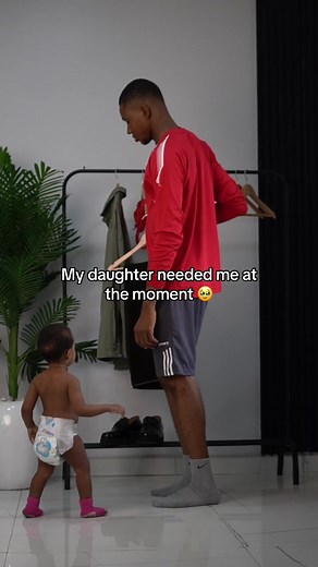 Cuddles Interrupted: A Dad's Adorable Moment with Baby Jasmine