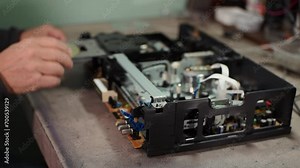 electronics repair. repair of consumer electronics. put a CD in the player. CD player. slow-motion video. High quality video in 4k