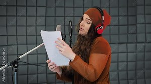 Voice acting of characters, recording in studio, reading text from script. Voice artist acting a role of some cartoon character
