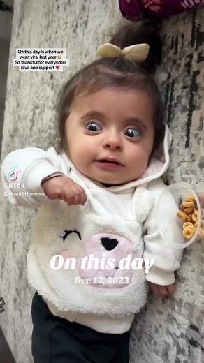 Cute Baby Enjoys Cheerios in the Kitchen
