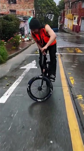 Guy riding bicycle in a unique style