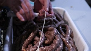 Sliding Hog Casing To The Tube Of A Sausage Stuffer Machine - Stuffing Sausage - close up