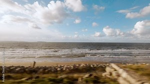 Travelling along the beautiful coast of Anglesey, North Wales UK, featuring fine sandy beaches Stock Video