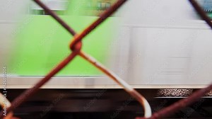 4K Tokyo: A Train Entering a Station Through a Rusty Wire Mesh with Sound