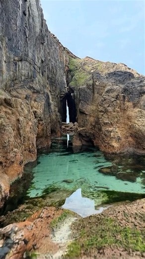In England, this hidden gem in Cornwall is a secluded cove near Land's End, famous for the "Song of the Sea", a magnificent natural rock arch that frames the turquoise Atlantic and its crystal-clear tidal pools. #travel #cornwall | UK Hidden Gems