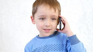 clip-1025399234-happy-child-talking-on-mobile-phone-white