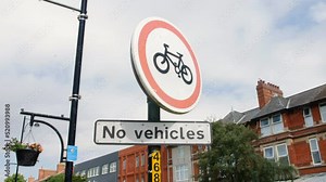 No vehicles sign and no bicycles on a road in a British town
