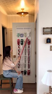 Abby Kulp DIY | DESIGN on Instagram: "🎀 Looking for a simple space saving solution for your wrapping paper?! Grab an over the door shoe storage organizer, choose two consecutive rows and cut the pouches open at the bottom. Make sure you leave the third consecutive row untouched! Slide your wrapping paper through the opened rows and use the rest of the rows for bows, ribbon, tape and more. #christmas #christmasdecorations #wrappingpaper #storagesolutions #organized #organizing #christmasmood"