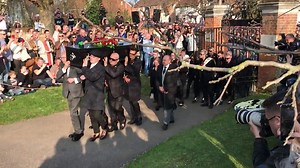 Keith Flint's coffin is carried into church by friends and fans