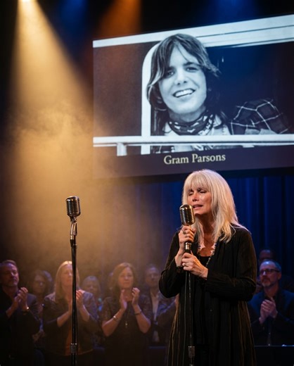 EMMYLOU HARRIS STILL LEAVES A SECOND MIC ON STAGE — 50 YEARS AFTER GRAM PARSONS DIED AT 26. NO ONE IS ALLOWED TO STAND THERE. "THAT'S NOT AN EMPTY SPOT," SHE ONCE SAID. "HE'S STILL SINGING." In 1972, Gram Parsons called a young Emmylou Harris and asked her to sing harmony. She had no career. No name. No idea that the next two years would define her entire life. They recorded together like two voices that had been searching for each other. Gram showed her how country music could break your heart 