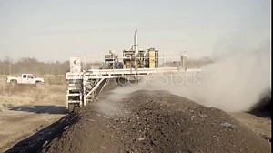 Large Compost Turner Turns Rows of Compost with Large Billowing Steam