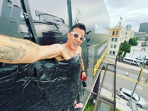 Steve-O duct-tapes himself to billboard to promote new special Gnarly