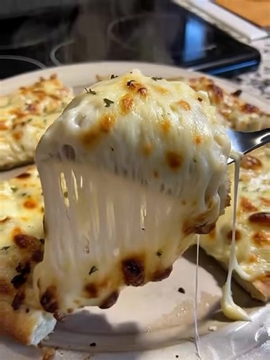 Best Garlic Cheese Fingers (Soft, Cheesy & Irresistible) Ingredients: 2 cups all-purpose flour, 1 tbsp sugar, 2 ¼ tsp instant yeast, ¾ tsp salt, ¾ cup warm milk, 2 tbsp olive oil or melted butter, 1 cup shredded mozzarella cheese. For garlic topping: 3 tbsp melted butter, 3 cloves garlic (minced), 1 tsp Italian seasoning, 2 tbsp chopped parsley, extra mozzarella or Parmesan for topping. Instructions: In a bowl, mix warm milk, sugar, and yeast and let it sit for 5 minutes until foamy. Add flour, 