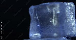 Aesthetic Ice Cubes closeup on black background, rotation