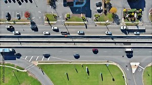 Road intersection urban transportation during rush hour with heavy traffic moving through intersection