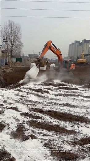 The process of excavator spreading lime powder at the construction site