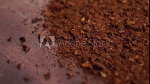 Soluble crushed dried chicory root on a wooden surface. Macro. Rotation. Healthy drink