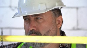 Senior architect or civil engineer using tape measure measuring to inspection wall and door at construction site. building project