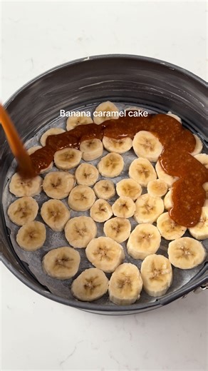 Recipe below 🤍 For the caramel banana layer: 2 bananas (sliced) 80g sugar 40g butter Cake: 2 ripe bananas (mashed) 2 medium eggs 130g caster sugar 100ml sunflower oil 80g yogurt (full fat) 1/2tsp vanilla 1/2tsp cinnamon 150g plain flour 1/2 tsp baking powder 1/2 tsp baking soda Prepare tin: grease and line an 8inch cake tin with baking paper (tin with removable base) Slice bananas and arrange in the tin. Make the cake batter: Whisk together the mashed bananas and egg by hand or electric whisk A