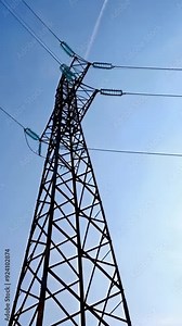High voltage steel power pylons in field covered. Power transmission lines. Electric tower line, sunrise sunset Stock Video