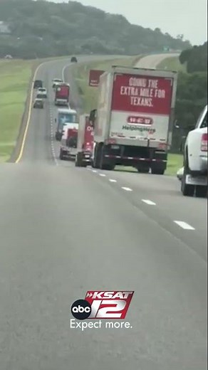 Convoy of H-E-B trucks and trailers labeled “disaster relief” traveling toward Comfort.
