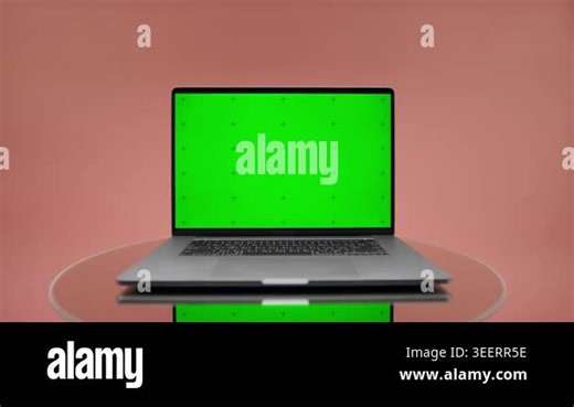 Studio pack shot reveal of an open laptop with green chroma key screen, reflection, and pink background Stock Video Footage - Alamy