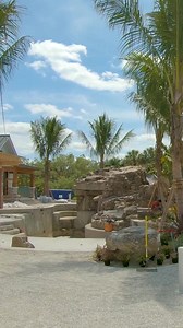 This backyard has an amazing slide, natural rock grotto, sunken fire pit, spa, putting green, and beautiful landscaping. What do you think of this backyard? #insanepools #lucaslagoons #poolbuilding #waterslide #backyardinspo #backyard #pool #luxurylife #luxuryhome | Lucas Lagoons