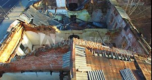 Aerial view of old house ruins from above. Camera moves slowly capturing ruins low altitude