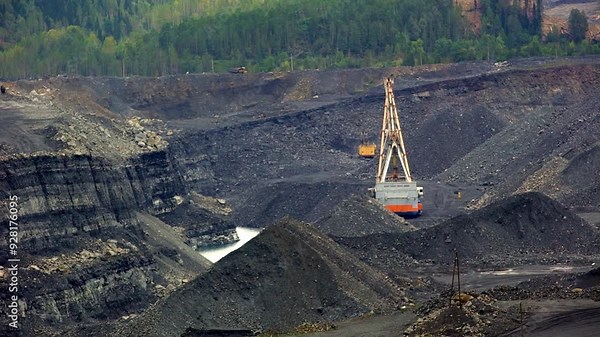 Heavy Machinery Utilized Within an Open Pit Mining Operation and Site for Extraction Activities. Stock Clip