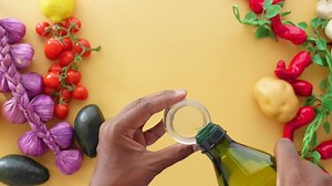 Download top view of pouring olive oil in a container for free