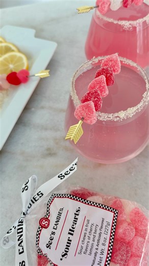 See's Candies on Instagram: "Sour Heart Fizz 🍸 🏹 With notes of cherry and lemon, this cocktail is perfect for Galentine’s Day. Cheers to sweet and sour perfection! 🍋🍒 Ingredients • 1 oz cherry syrup (or grenadine) • 1 oz fresh lemon juice • 0.5 oz simple syrup (optional for extra sweetness) • Soda water or lemon-lime soda (for topping) 2 oz vodka (or white rum for a sweeter variation) • Ice cubes Garnish and Rim • See’s Candies Sour Hearts • Granulated sugar and remnants from the Sour Hearts