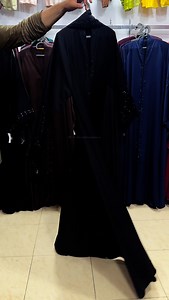 Original Saudi Nida Fabric Fully Flared Abaya (loose fit) Lazer cutwork sleeves with tussles Embroidered and embellished with stones Matching embroidered hijab 56-57 inches length | Al-Haya Dream Abayas