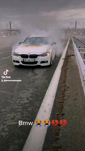 White BMW Car Engulfed in Flames on the Road