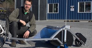 Motorized bike trailer clears lanes of dangerous glass and debris