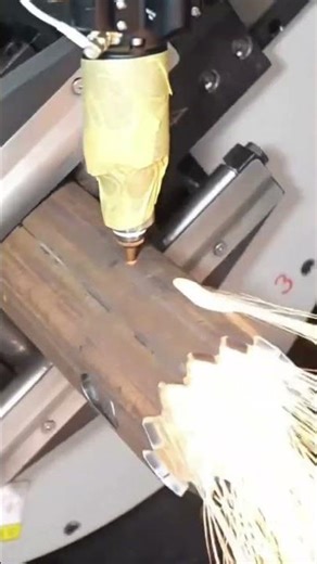 A laser cutting machine precisely slicing through a rotating steel pipe #construction #popular