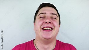 Positive and joyful Caucasian male bursting into laughing holding his hands on stomach can`t stopping laughing after hearing funny anecdote. Positive emotions and humour. Red face with laughter Stock Video
