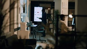 Panning shot of african american employees auditing accounting payroll reports and tables on computer screen during nightshift. Company personnel working overnight on project before deadline