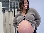 Ashley Graham models her beautiful baby bump during rooftop fashion photoshoot