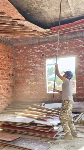 Removing Temporary Ceiling Formwork in a Brick Building Under Construction
