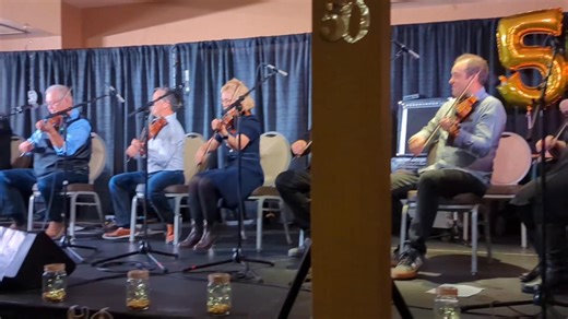 Eight Canadian Grand Champion Fiddlers on stage with Calvin Vollrath at the North American Fiddlers Convention on Saturday night at the Wyndham Edmonton Hotel and Conference Center . | Bill Borgwardt