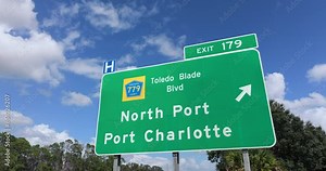 American freeway exit sign in Florida. I-75 highway junction with direction to North Port and Port Charlotte Stock Video