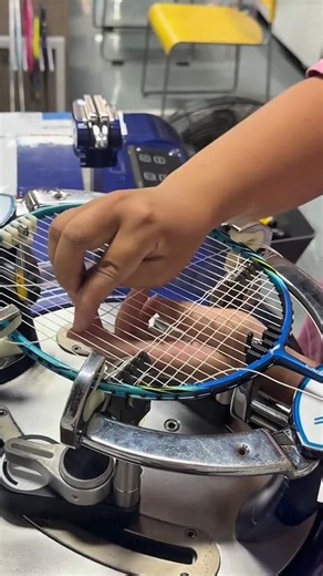 Restringing a badminton racket with a high-tension electronic stringing machine