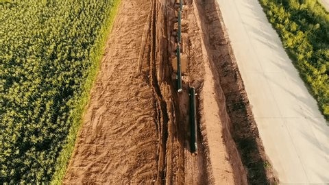 clip-4004299065-aerial-view-pipeline-construction-running-alongside-road