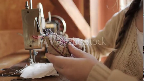seamstress selects needles and pins for sewing in front antique sewing machine in vintage room, Tools, Equipment used for sewing, , past and present, connection between generations, Cozy atmosphere