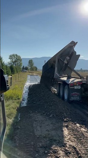 Side-dump spreading gravel.